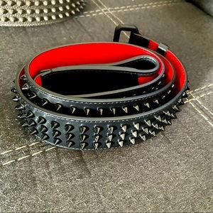 CL belt - the brand's iconic spikes & lined in signature logo-embossed red.